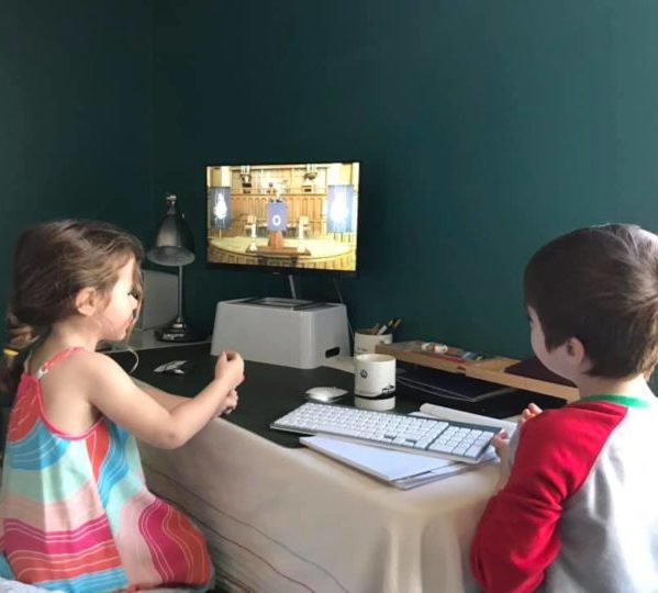 Two children joining First Church worship online